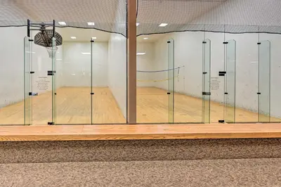 a basketball court with glass dividers in a gym at Cozy and Chic Mountain Condo with Community Perks in Fraser