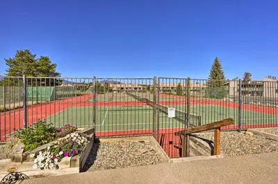 a baseball field with a fence and some flowers at Cozy and Chic Mountain Condo with Community Perks in Fraser