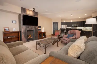 a living room with a couch and a fireplace at Parry Peak Loft Premium-Rated 105 in Winter Park