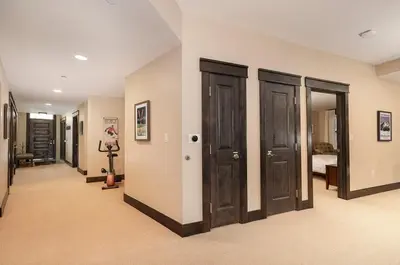 a hallway with wooden doors in a house at Parry Peak Loft Premium-Rated 105 in Winter Park