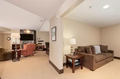 a living room with a couch and a table at Parry Peak Loft Premium-Rated 105 in Winter Park