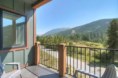 a balcony with chairs and a view of the mountains at Brand New Clear Water Lofts - 2br Premier Condo - Kids Ski Free, No CF condo in Keystone