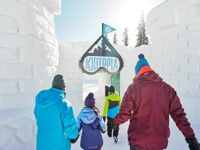 a group of people walking in the snow at Brand New Clear Water Lofts - 2br Premier Condo - Kids Ski Free, No CF condo in Keystone