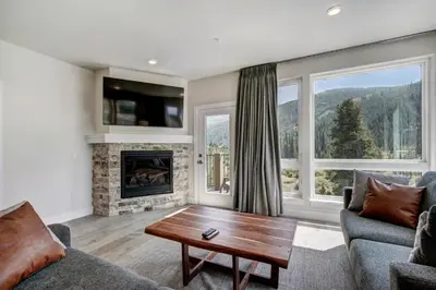 a living room with a fireplace and a table at Brand New Clear Water Lofts - 2br Premier Condo - Kids Ski Free, No CF condo in Keystone