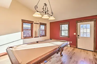 a pool table in a room with red walls at Mtn View and Group Ready Conifer Home on 100 Acres! in Conifer