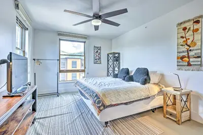 a bedroom with a bed and a flat screen tv at 3 Mi to Dillon Reservoir Condo with Balcony! in Silverthorne