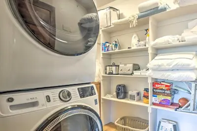 a washer and dryer in a room with shelves at 3 Mi to Dillon Reservoir Condo with Balcony! in Silverthorne