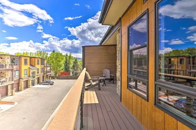 a balcony with a table and chairs on a building at 3 Mi to Dillon Reservoir Condo with Balcony! in Silverthorne