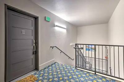 a hallway with a black door and a blue carpet at 3 Mi to Dillon Reservoir Condo with Balcony! in Silverthorne