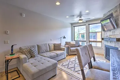 a living room with a couch and a fireplace at 3 Mi to Dillon Reservoir Condo with Balcony! in Silverthorne