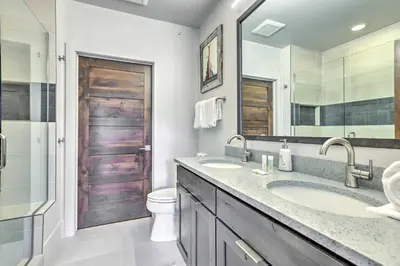 a bathroom with a sink and a toilet and a mirror at 3 Mi to Dillon Reservoir Condo with Balcony! in Silverthorne