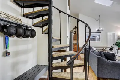 a spiral staircase in a living room with a couch at Luxury 2 Bedroom Condo with Pool Hot Tub and Sauna in Keystone