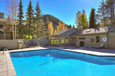 a swimming pool in front of a house at Luxury 2 Bedroom Condo with Pool Hot Tub and Sauna in Keystone