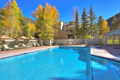 a swimming pool in a yard with a house at Luxury 2 Bedroom Condo with Pool Hot Tub and Sauna in Keystone
