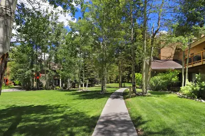 a walkway in a yard next to a building at Luxury 2 Bedroom Condo with Pool Hot Tub and Sauna in Keystone
