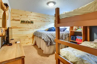a bedroom with two bunk beds and a desk at Silverthorne Condo with Lake Views 10 Mi to Skiing! in Silverthorne