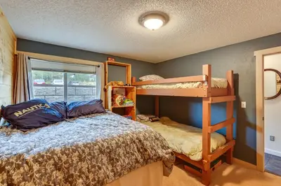 a bedroom with two bunk beds and a window at Silverthorne Condo with Lake Views 10 Mi to Skiing! in Silverthorne