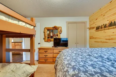 a bedroom with a bunk bed and a mirror at Silverthorne Condo with Lake Views 10 Mi to Skiing! in Silverthorne