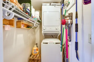 a utility room with a toilet and a refrigerator at Silverthorne Condo with Lake Views 10 Mi to Skiing! in Silverthorne