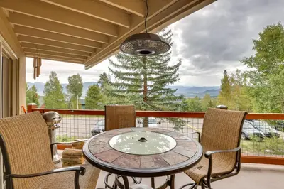 a table and chairs on a balcony with a view at Silverthorne Condo with Lake Views 10 Mi to Skiing! in Silverthorne