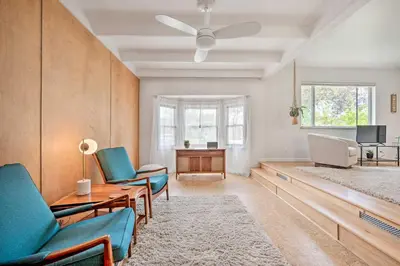 a living room with blue chairs and a table at Less Than 3 Mi to Pearl St Home with Large Yard in Boulder in Boulder