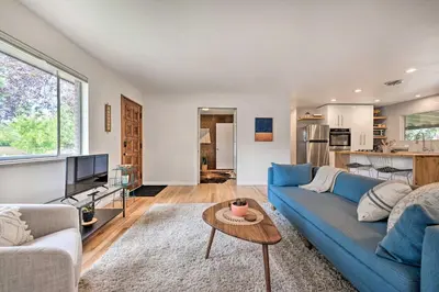 a living room with a blue couch and a table at Less Than 3 Mi to Pearl St Home with Large Yard in Boulder in Boulder