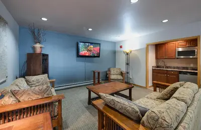 a living room with two couches and a kitchen at Cedar Lodge Buffalo Studio Condo: Great Frisco Location in Frisco