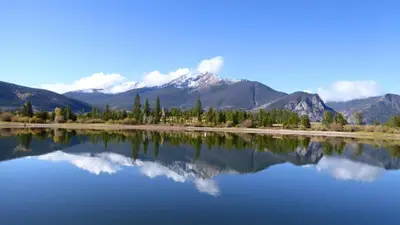 a reflection of a mountain in the water at Cedar Lodge Buffalo Studio Condo: Great Frisco Location in Frisco