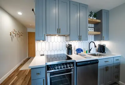 a kitchen with blue cabinets and a sink at Cedar Lodge Buffalo Studio Condo: Great Frisco Location in Frisco