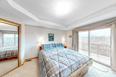 a bedroom with a bed and a large window at Cozy Fraser Cabin in Fraser