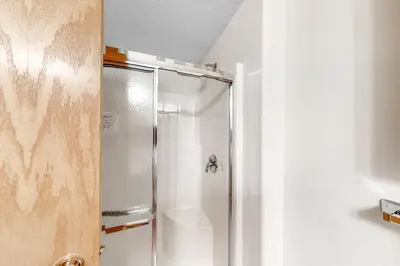a shower with a glass door in a bathroom at Cozy Fraser Cabin in Fraser