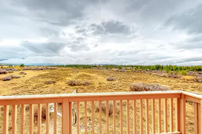 a view of a field from the deck of a house at Cozy Fraser Cabin in Fraser