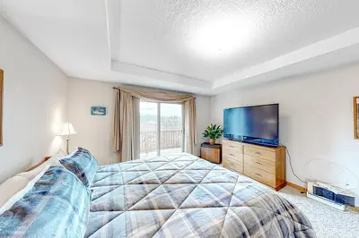 a bedroom with a large bed and a flat screen tv at Cozy Fraser Cabin in Fraser