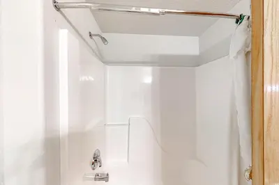a shower in a bathroom with a shower curtain at Cozy Fraser Cabin in Fraser
