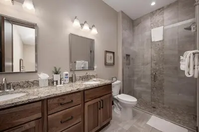 a bathroom with a toilet and a sink and a shower at Elk Creek Condos B103 by Stay Winter Park in Fraser