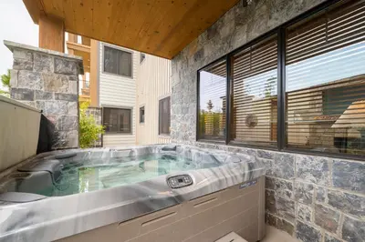 a large jacuzzi tub in a house at Elk Creek Condos B103 by Stay Winter Park in Fraser