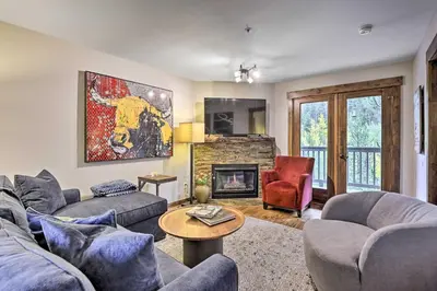 a living room with two couches and a fireplace at Main Street Frisco Condo with Private Patio! in Frisco
