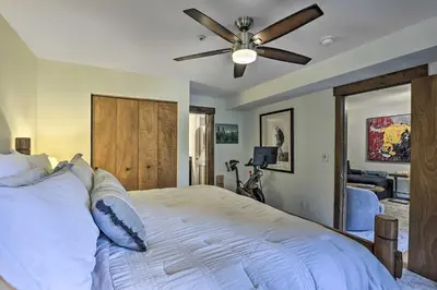 a bedroom with a bed with a ceiling fan at Main Street Frisco Condo with Private Patio! in Frisco