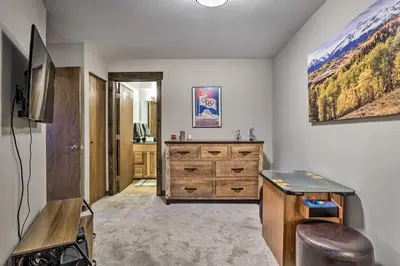 a room with a dresser and a television in it at Main Street Frisco Condo with Private Patio! in Frisco