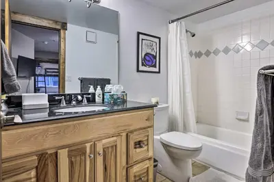 a bathroom with a sink and a toilet and a tub at Main Street Frisco Condo with Private Patio! in Frisco