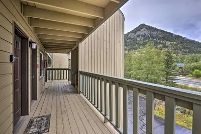 a balcony of a building with a view of a mountain at Main Street Frisco Condo with Private Patio! in Frisco