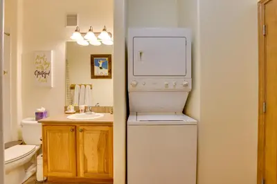 a bathroom with a white refrigerator and a sink at Ski and Explore Silverthorne Gem with Hot Tub Access! in Silverthorne