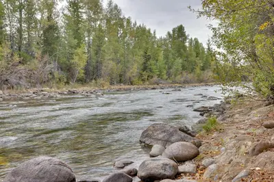 a river with rocks and trees in the background at Ski and Explore Silverthorne Gem with Hot Tub Access! in Silverthorne