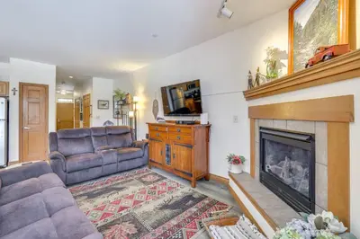 a living room with a couch and a fireplace at Ski and Explore Silverthorne Gem with Hot Tub Access! in Silverthorne
