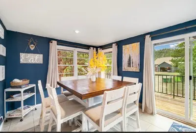 a dining room with a wooden table and chairs at Hot Tub! Pets Ok! Perfect Estes Park Getaway, Walk to Town 3 Kings!#3337 in Estes Park