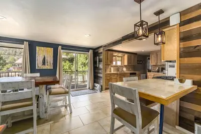 a kitchen with a table and chairs in a room at Hot Tub! Pets Ok! Perfect Estes Park Getaway, Walk to Town 3 Kings!#3337 in Estes Park