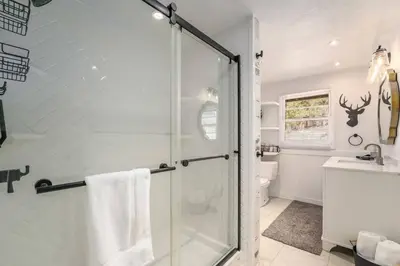 a bathroom with a shower with a glass door at Hot Tub! Pets Ok! Perfect Estes Park Getaway, Walk to Town 3 Kings!#3337 in Estes Park
