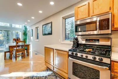 a kitchen with a stove and a microwave at Less Than 1 Mi to Dtwn Creekside Frisco Home with Fire Pit in Frisco