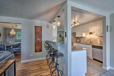 a kitchen and living room with a table and chairs at Fenced Yard and Patio Pet-Friendly Denver Home Base in Arvada