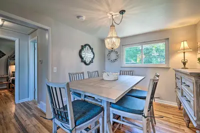 a dining room with a wooden table and chairs at Fenced Yard and Patio Pet-Friendly Denver Home Base in Arvada